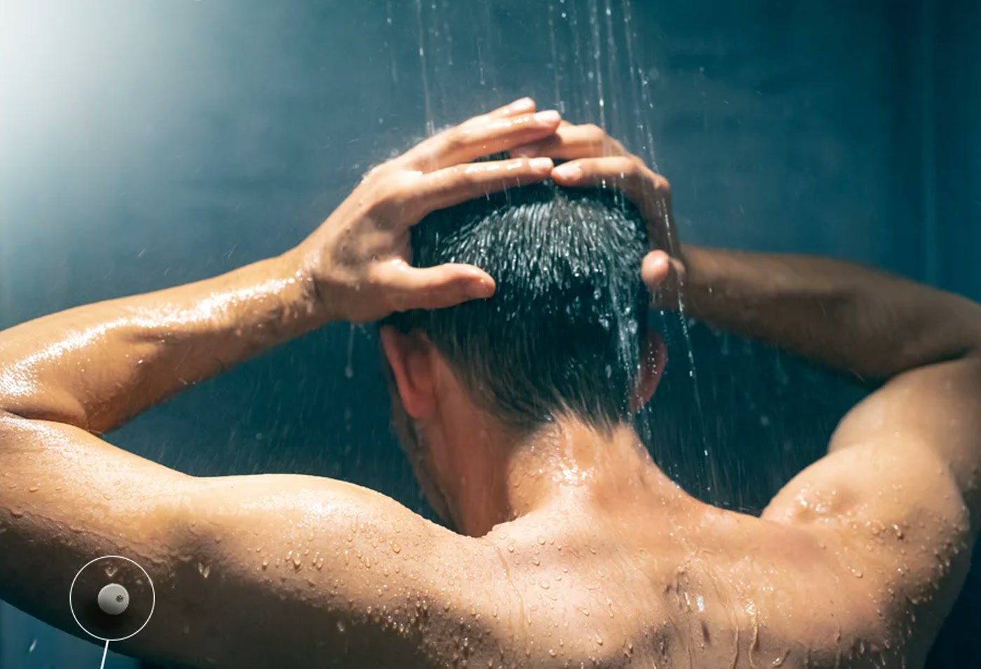 A person showering with the LinX sensor visible on their upper arm, unaffected by the water